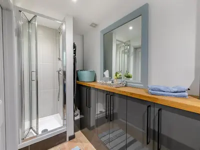 a bathroom with a shower and a mirror at Riverside Barn in Newquay