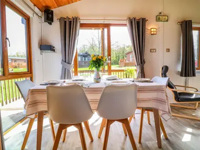 a dining room with a table and chairs at 3 The Glade in Wadebridge