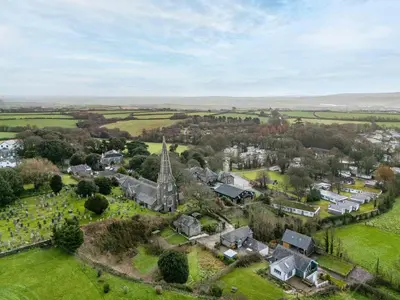 an aerial view of a small village with a church at 3 The Glade in Wadebridge