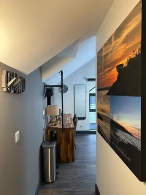a hallway with a desk and a painting on the wall at Uno in the City - Urban Boutique Accommodation in Truro