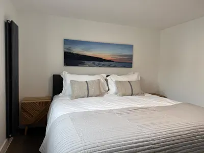 a bedroom with a large white bed with pillows at Uno in the City - Urban Boutique Accommodation in Truro