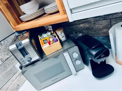 a kitchen counter with a microwave and a coffee maker at Uno in the City - Urban Boutique Accommodation in Truro