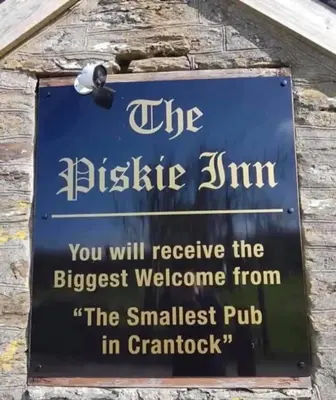 a sign on the side of a building at Cosy 2 bed pet friendly holiday home Crantock Nr Newquay in Crantock
