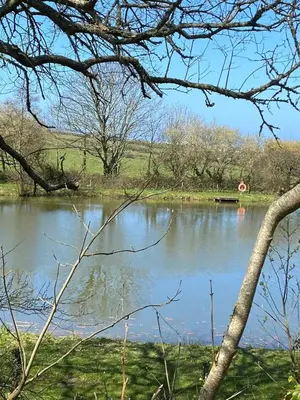 a body of water with a stop sign in the distance at Cosy 2 bed pet friendly holiday home Crantock Nr Newquay in Crantock