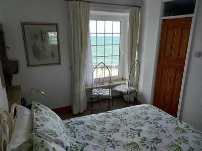 a bedroom with a bed and a window at The Rookery in St Ives