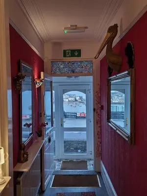 a hallway with a door with a view of the water at The Rookery in St Ives