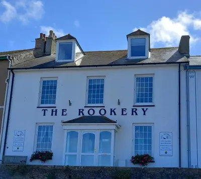 a white building with the roodery sign on it at The Rookery in St Ives