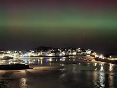 a view of a beach at night with lights at The Rookery in St Ives