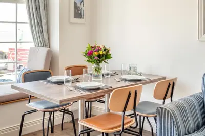 a dining room table with chairs and a vase of flowers at 2 Bed in St. Ives oc-h28027 in St Ives