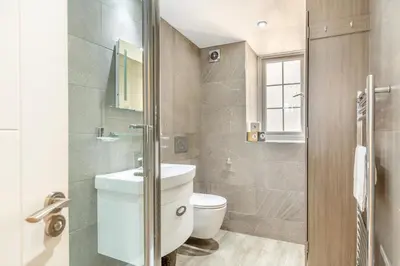 a bathroom with a toilet and a glass shower at 2 Bed in St. Ives oc-h28027 in St Ives