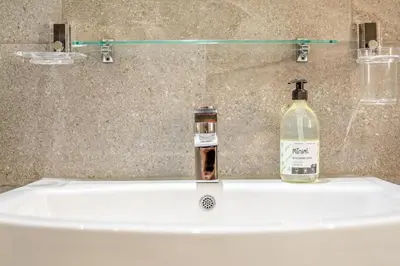 a bathroom sink with a bottle of alcohol on it at 2 Bed in St. Ives oc-h28027 in St Ives