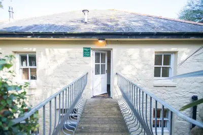 a stairway leading to a white building with a white door at Tregenna Castle Self Catering in St Ives