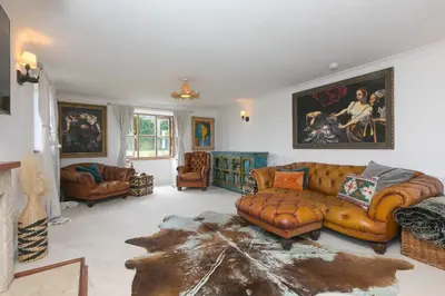 a living room with a couch and two chairs at Lanyon in St Ives