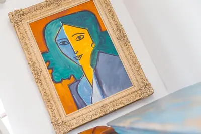 a painting of a woman with green hair in a gold frame at Lanyon in St Ives