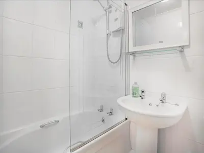 a white bathroom with a sink and a shower at 31 Lower Elms in Saint Minver