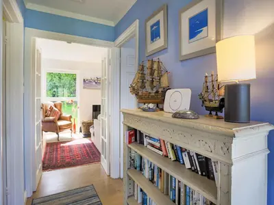 a room with a book shelf filled with books at 31 Lower Elms in Saint Minver