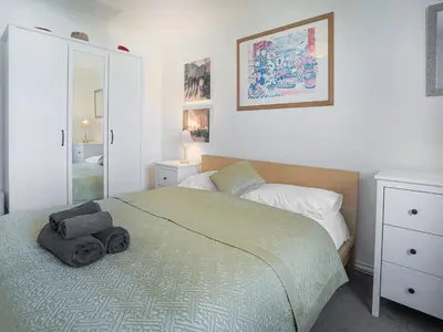 a bedroom with a bed and a mirror at 31 Lower Elms in Saint Minver