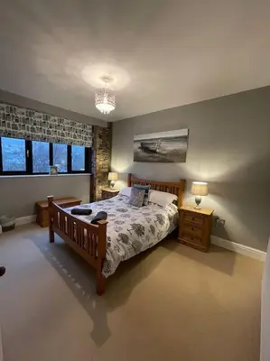 a bedroom with a large bed and two night stands at No1 Cottage Mevagissey in Mevagissey