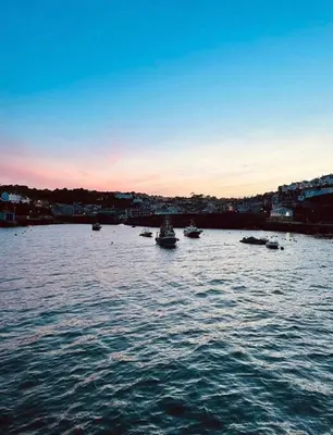 a group of boats in a large body of water at No1 Cottage Mevagissey in Mevagissey