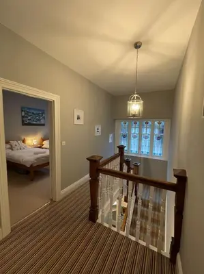 a room with a staircase with a bed and a window at No1 Cottage Mevagissey in Mevagissey