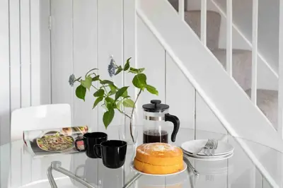 a glass table with a coffee maker and a cake on it at The Old Shop in Withiel Village with private enclosed garden in Withiel