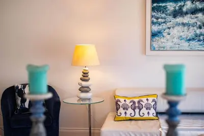 a living room with a lamp and a couch at Derowen, Port Isaac Bay Holidays in Port Isaac