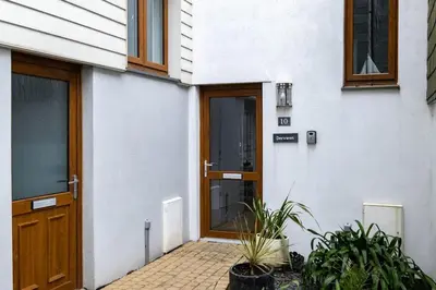 a door of a house with plants in front of it at Derowen, Port Isaac Bay Holidays in Port Isaac
