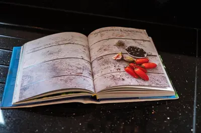an open book with vegetables on the pages at Derowen, Port Isaac Bay Holidays in Port Isaac