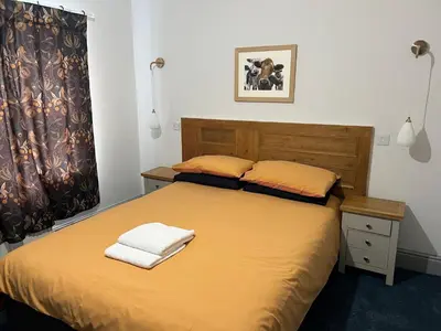 a bedroom with a bed with two towels on it at Highermead House in Camelford