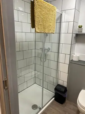 a shower with a glass door in a bathroom at Highermead House in Camelford