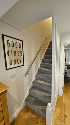 a staircase in a home with a sign that reads good vibes only at Perran Beach House in Perranporth