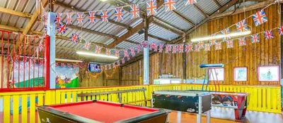 a room with a pool table and flags at Holiday Home - St Austell in St Austell