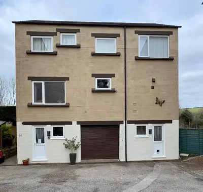 a large brick house with a garage at Detached Home Close to the Beach Newquay in Saint Columb Minor