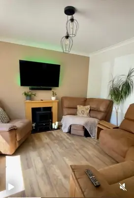 a living room with a couch and a tv on a wall at Detached Home Close to the Beach Newquay in Saint Columb Minor