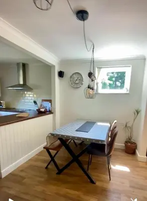a table with a laptop on it in a kitchen at Detached Home Close to the Beach Newquay in Saint Columb Minor