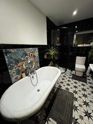 a bathroom with a bath tub and a sink at Detached Home Close to the Beach Newquay in Saint Columb Minor