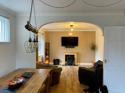 a living room with a couch and a table at Detached Home Close to the Beach Newquay in Saint Columb Minor