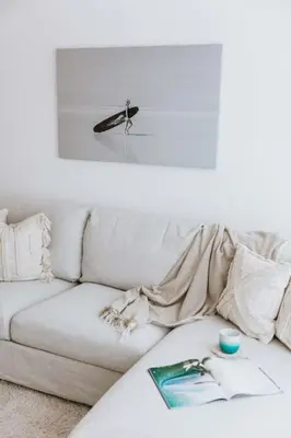 a living room with a white couch and a table at The Surf House Fistral in Newquay