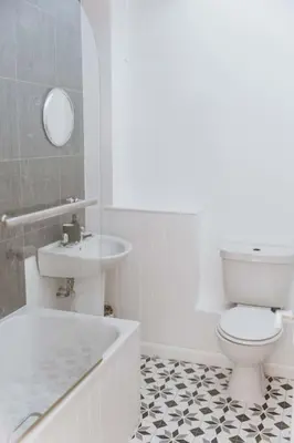 a bathroom with a tub and a toilet and a sink at The Surf House Fistral in Newquay