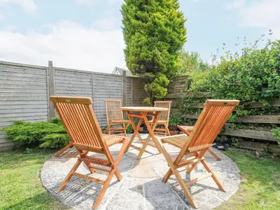 a group of chairs and a table on a patio at Sea Drift in St Austell