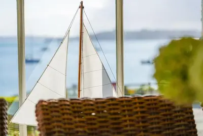 aicker basket with a sail boat in a window at Beachfront home with spectacular sea views in Saint Mawes