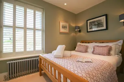 a bedroom with a bed with two books on it at Beachfront home with spectacular sea views in Saint Mawes