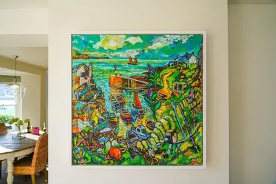 a painting hanging on a wall in a dining room at Beachfront home with spectacular sea views in Saint Mawes