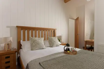 a bedroom with a bed with a basket on it at 10 Stonerush Valley in Looe