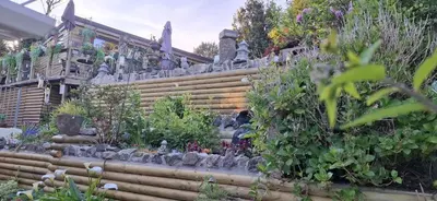 a garden with stairs and plants in front of a house at Cosy Cornish Cabin in St Austell