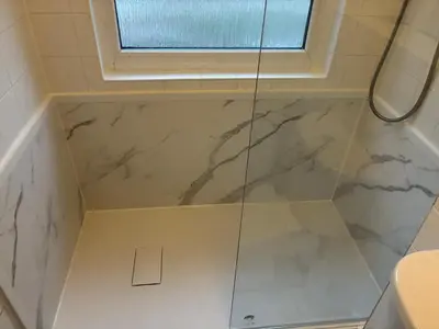 a bathroom with a shower with white marble at Kerenza Cottage - Families & Pets in Uny Lelant
