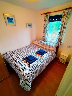 a bedroom with a bed with two towels on it at Kerenza Cottage - Families & Pets in Uny Lelant