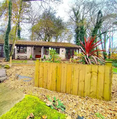 a wooden fence in front of a house at Kerenza Cottage - Families & Pets in Uny Lelant