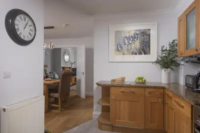 a kitchen with a large clock on the wall at 7 Wheal Ayr, St Ives in St Ives