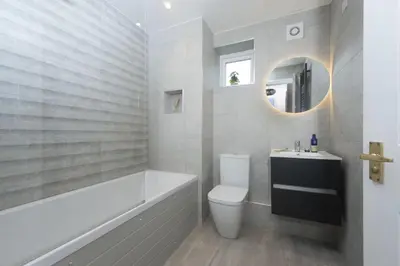 a bathroom with a tub and a toilet and a sink at 7 Wheal Ayr, St Ives in St Ives